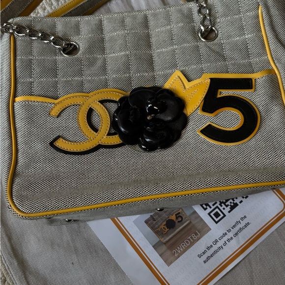 CHANEL Handbags - CHANEL Beige Canvas Shoulder Bag with Yellow Trim and Black Camellia